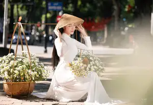 Vietnamese Ao Dai Beauty: Graceful girl with white daisies, an enchanting blend of tradition and charm. - image 3