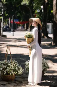 Vietnamese Ao Dai Beauty: Graceful girl with white daisies, an enchanting blend of tradition and charm. - image 2