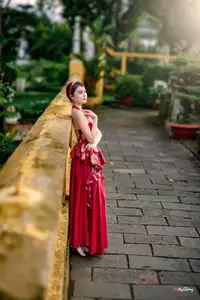 Elegant Asian Beauty in Red Dress Shines Gracefully Amidst a Traditional Garden 1000024509 - image 0