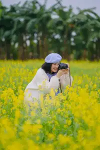 Immerse in Golden Rapeseed Fields: Girl's Artistic Photography Amidst Peaceful Charm, Attracting Year-End Visitors. - image 1