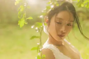 Dreamy Reflection: Girl in white dress finds gentle elegance in a garden mirror. - image 0