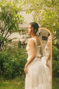 Dreamy Reflection: Girl in white dress finds gentle elegance in a garden mirror. - image 2