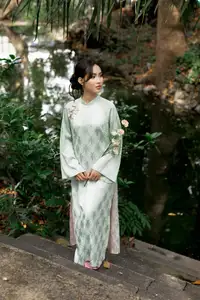 Graceful Vietnamese Woman in Light Green Ao Dai Amidst Tranquil Garden - image 8