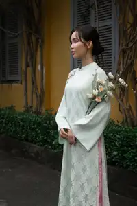 Graceful Vietnamese Woman in Light Green Ao Dai Amidst Tranquil Garden - image 7