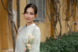 Graceful Vietnamese Woman in Light Green Ao Dai Amidst Tranquil Garden - image 9