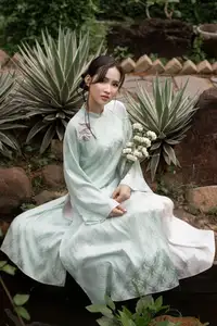 Graceful Vietnamese Woman in Light Green Ao Dai Amidst Tranquil Garden - image 10