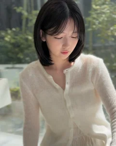 Timeless elegance of classic black bob hair amidst the lush green forest - image 3