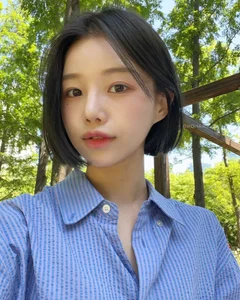 Timeless elegance of classic black bob hair amidst the lush green forest - image 1