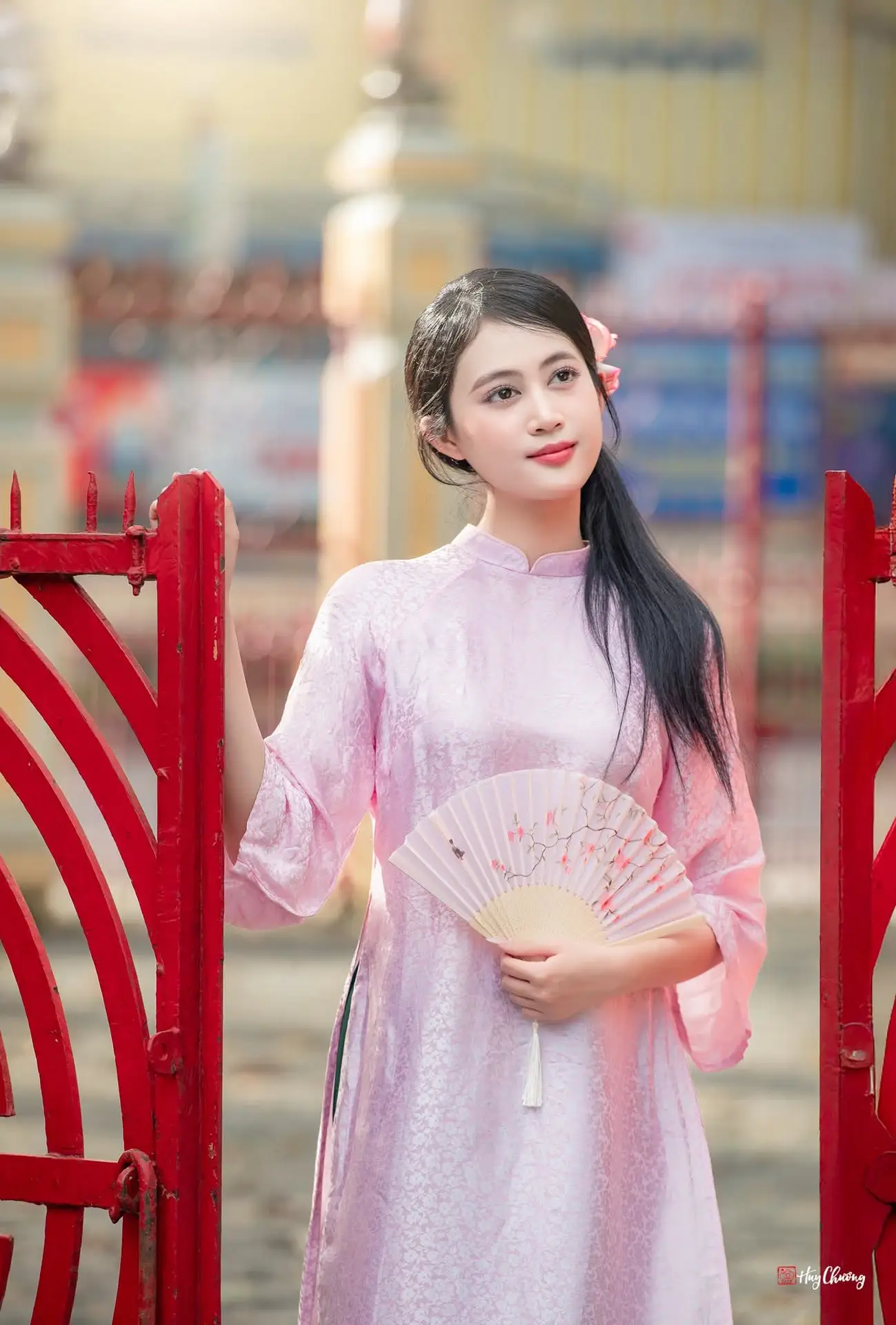 VGU No.163: The Graceful Beauty of a Vietnamese Girl in Traditional Pink Ao Dai Amidst Ancient Architecture