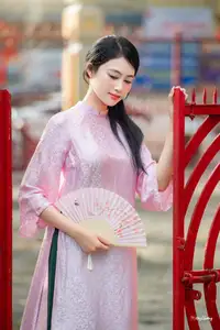 VGU No.163: The Graceful Beauty of a Vietnamese Girl in Traditional Pink Ao Dai Amidst Ancient Architecture - image 4