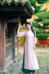 VGU No.163: The Graceful Beauty of a Vietnamese Girl in Traditional Pink Ao Dai Amidst Ancient Architecture - image 2