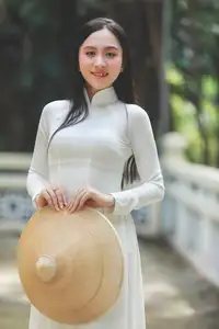 Elegant Vietnamese Woman in White Ao Dai: A Portrait of Traditional Grace and Conical Hat - image 6