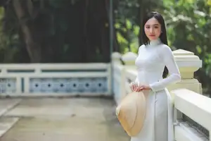 Elegant Vietnamese Woman in White Ao Dai: A Portrait of Traditional Grace and Conical Hat - image 4