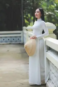 Elegant Vietnamese Woman in White Ao Dai: A Portrait of Traditional Grace and Conical Hat - image 2
