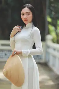 Elegant Vietnamese Woman in White Ao Dai: A Portrait of Traditional Grace and Conical Hat - image 7