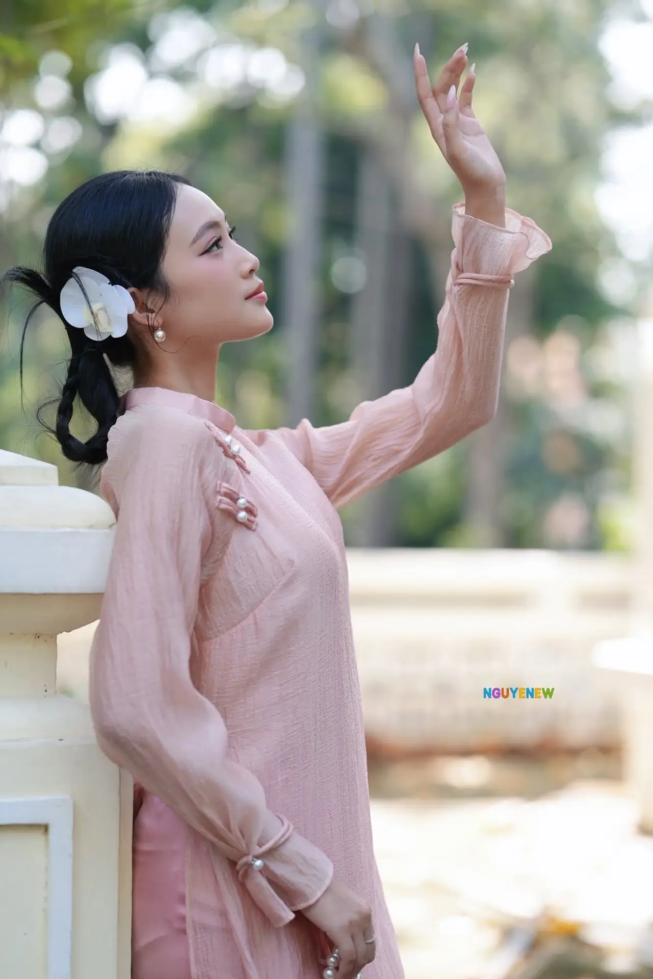 Timeless Beauty: Elegant Vietnamese Girl in Graceful Pink Ao Dai 1000024694
