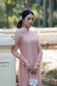 Timeless Beauty: Elegant Vietnamese Girl in Graceful Pink Ao Dai 1000024694 - image 3