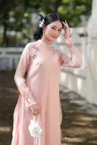 Timeless Beauty: Elegant Vietnamese Girl in Graceful Pink Ao Dai 1000024694 - image 2