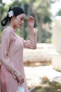 Timeless Beauty: Elegant Vietnamese Girl in Graceful Pink Ao Dai 1000024694 - image 1