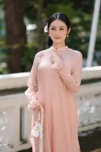 Timeless Beauty: Elegant Vietnamese Girl in Graceful Pink Ao Dai 1000024694 - image 6