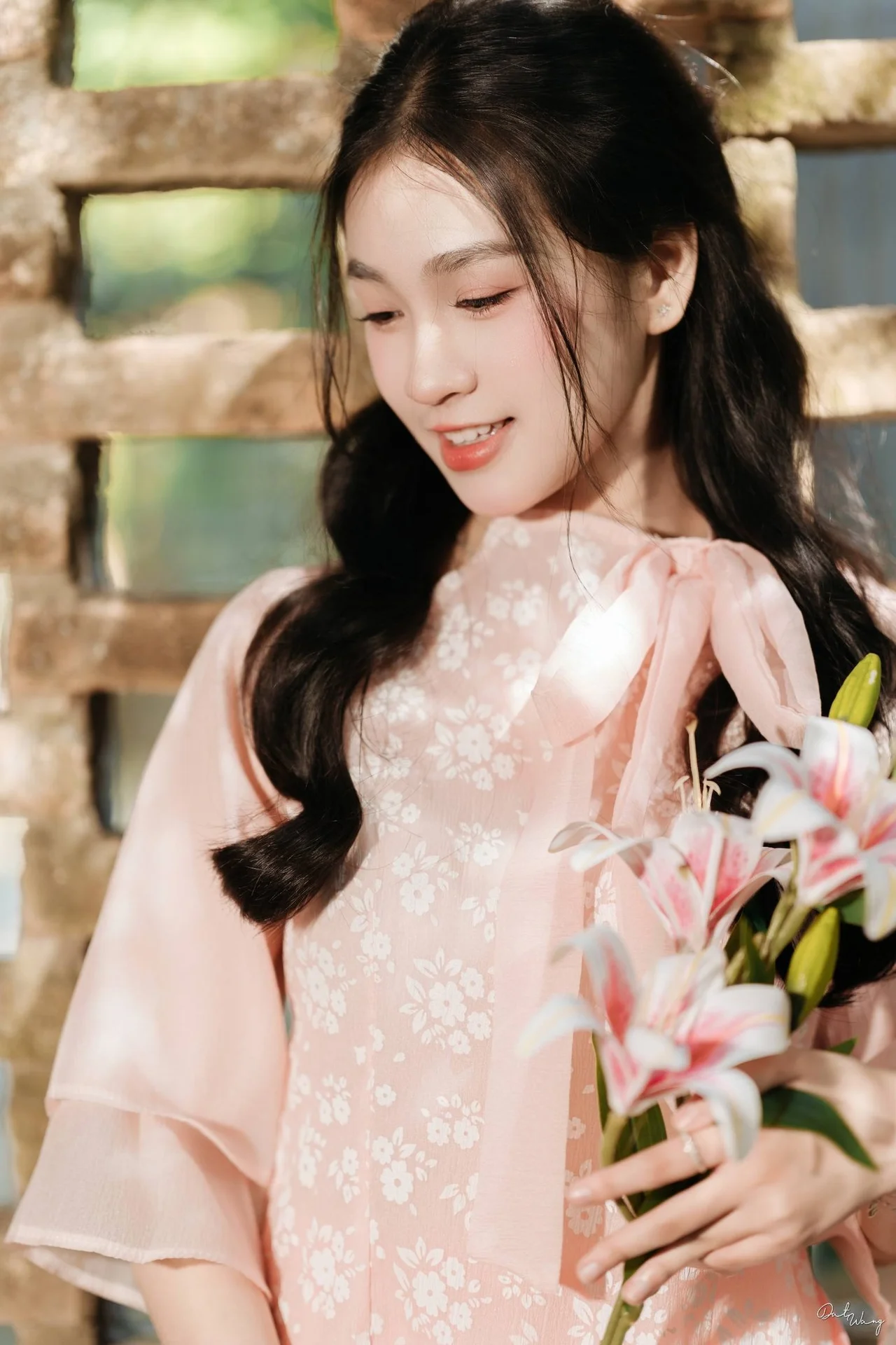 Poetic Beauty in Pink Ao Dai and White Lilies