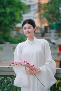 Pure Beauty: Girl in White with Orchids - Grace and Serenity of East Asian Charm - image 3