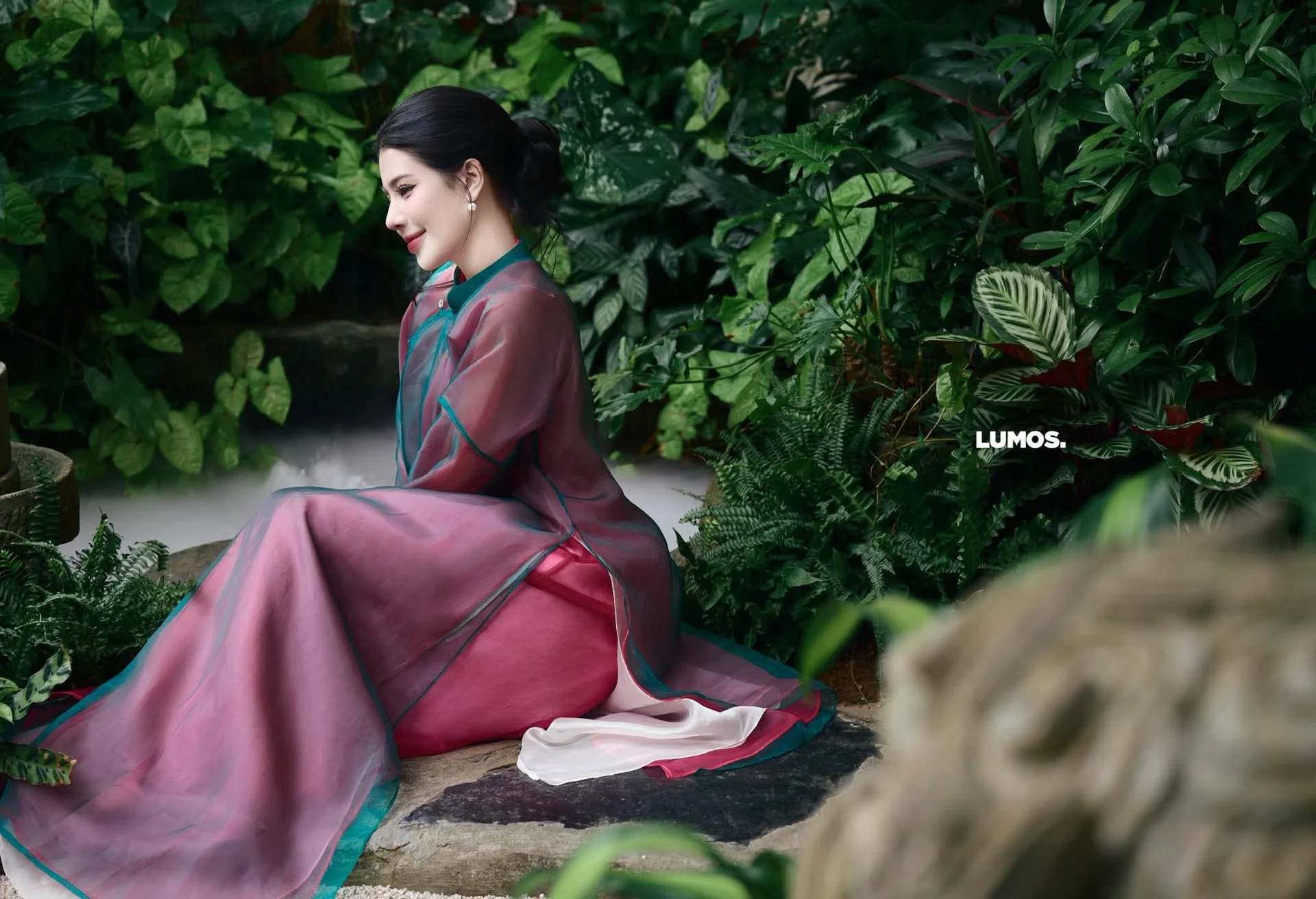 Graceful East Asian Beauty: Traditional Charm in a Lush Green Garden