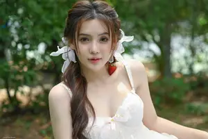 Ethereal Beauty: Young Woman in White Amidst Lush Green Nature - image 0
