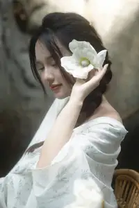 Serene Asian Beauty: A Delicate Moment with a White Flower - image 3