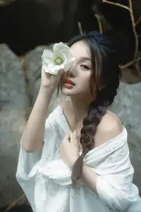 Serene Asian Beauty: A Delicate Moment with a White Flower - image 1