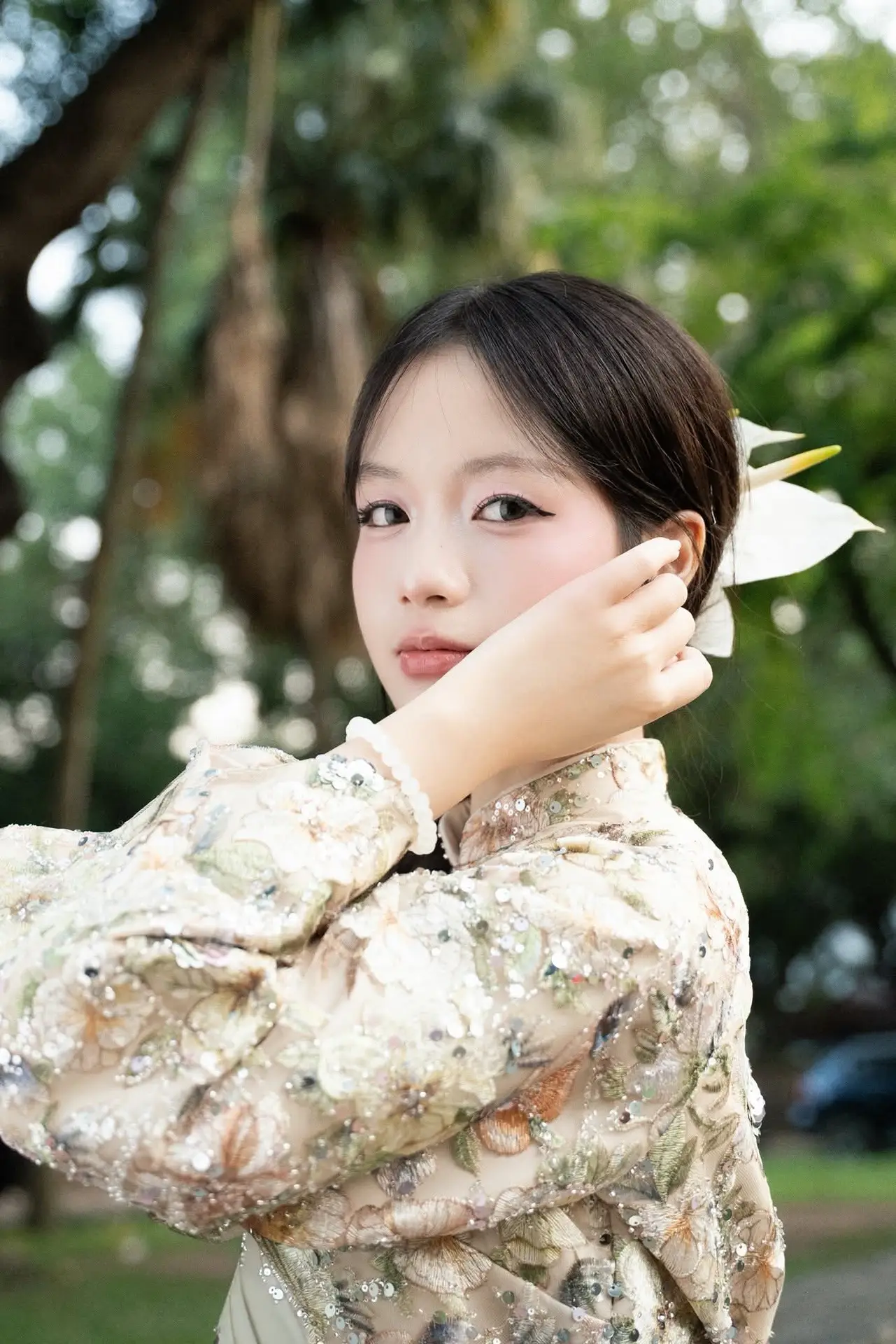 East Asian Traditional Beauty: Gentle Young Woman in Ao Dai with Elegant Wooden Fan