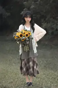 Youthful Beauty: A Gentle Girl Embracing Radiant Sunflowers - image 0