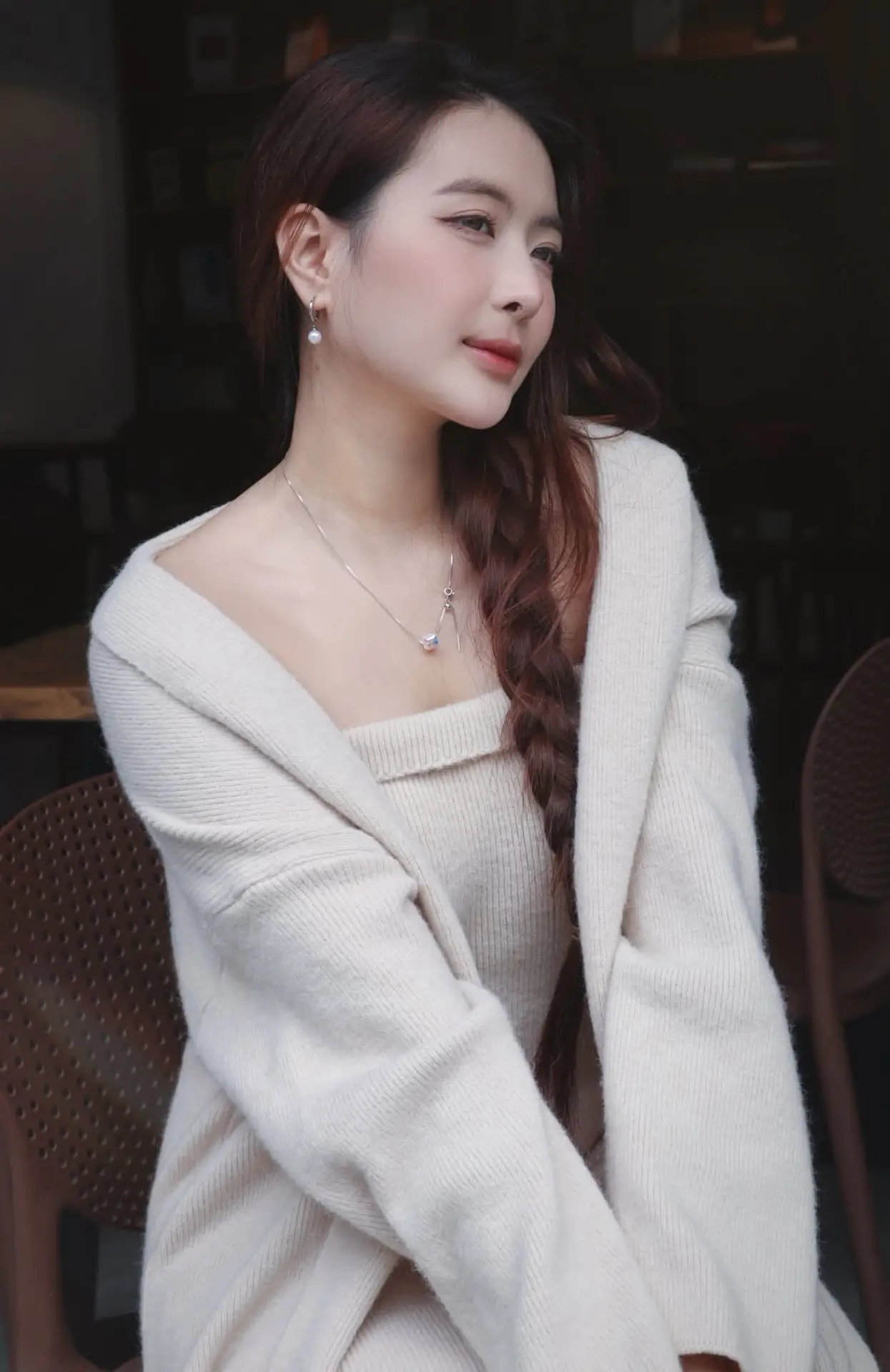 Discover the elegant charm of a gentle woman captured in a serene, thoughtful moment 176403855