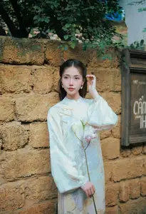 Captivating Asian Beauty: Elegant Woman Embracing Delicate Flowers - image 2