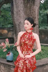 Graceful Asian Woman in Vibrant Red Floral Dress: Timeless Elegance by the Ancient Tree 1000024556 - image 0