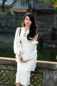Elegant Beauty in Pristine White Dress Under Golden Afternoon Sun 1000027006 - image 2