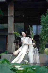 Timeless Grace: Vietnamese Woman in Modernized Ao Dai by a Serene Lotus Pond - image 0