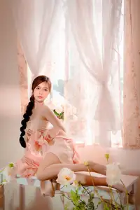 Ethereal Beauty: A Young Woman's Delicate Charm in a Flowing Pink Dress - image 1