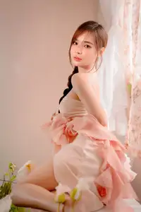 Ethereal Beauty: A Young Woman's Delicate Charm in a Flowing Pink Dress - image 2