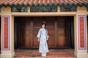 Timeless Grace in Blue Floral Ao Dai and Ancient Architecture - image 1