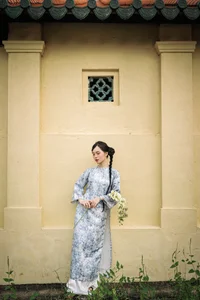 Timeless Grace in Blue Floral Ao Dai and Ancient Architecture - image 0