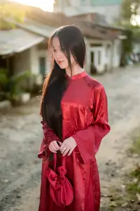 Elegant Vietnamese Beauty in Red Ao Dai: A Glimpse into Traditional Grace - image 0