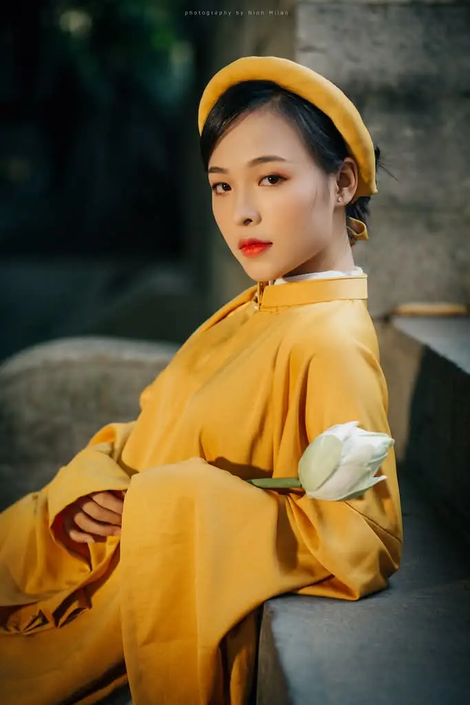 Discover the Graceful Beauty of a Vietnamese Woman in Radiant Yellow Ao Dai with Pure Lotus 1000025235