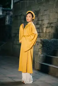 Discover the Graceful Beauty of a Vietnamese Woman in Radiant Yellow Ao Dai with Pure Lotus 1000025235 - image 1