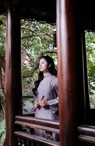 Ethereal Grace in Lavender Ao Dai Amidst Ancient Architecture - image 3