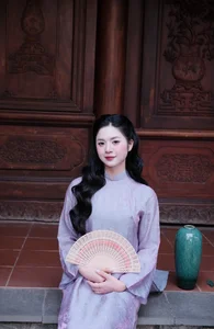 Ethereal Grace in Lavender Ao Dai Amidst Ancient Architecture - image 0