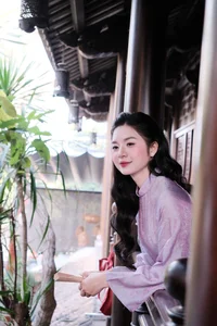 Ethereal Grace in Lavender Ao Dai Amidst Ancient Architecture - image 1