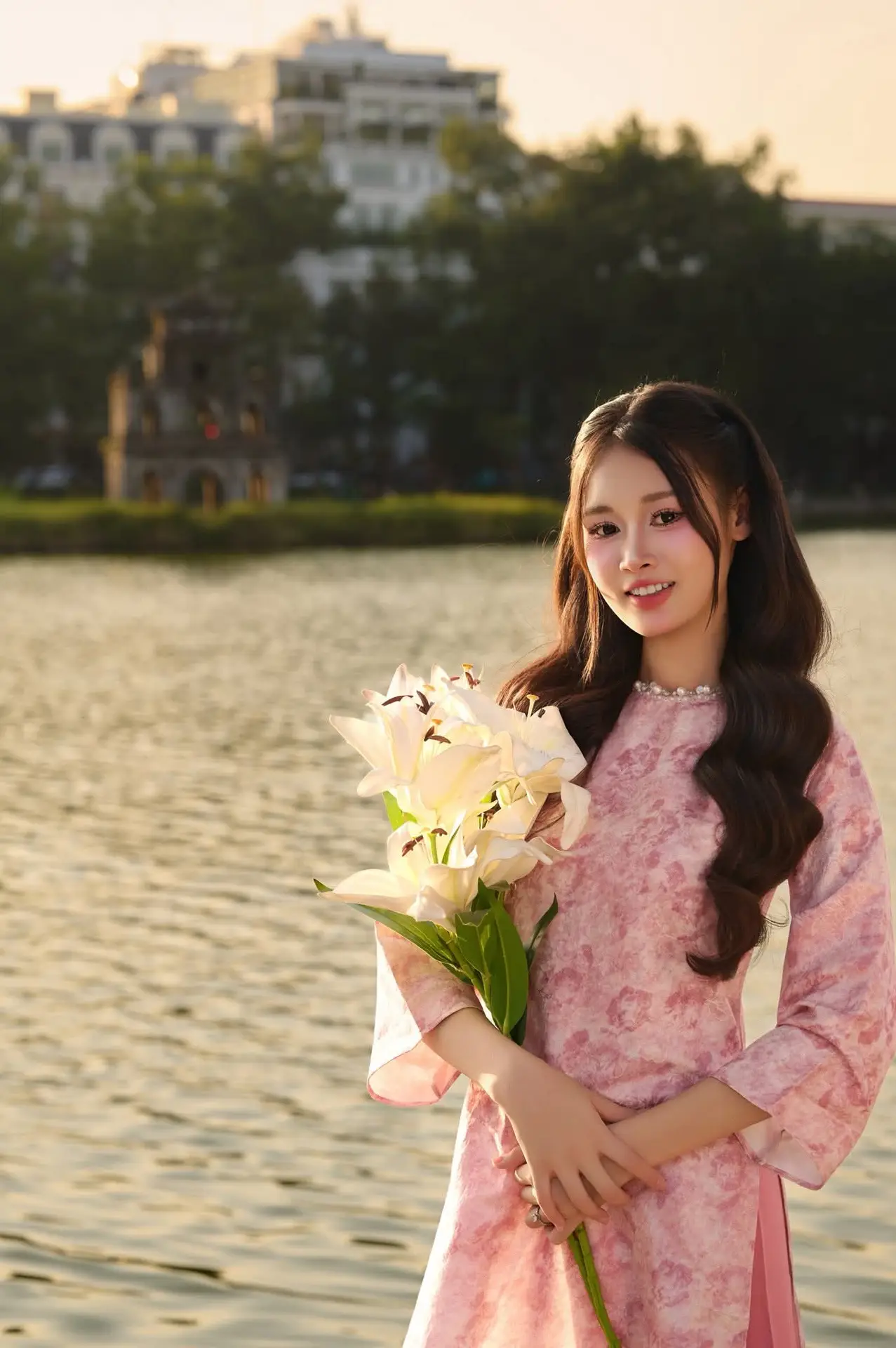 Gentle Vietnamese Beauty: Pink Ao Dai by the Lake, with Pure Lilies