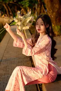 Gentle Vietnamese Beauty: Pink Ao Dai by the Lake, with Pure Lilies - image 1