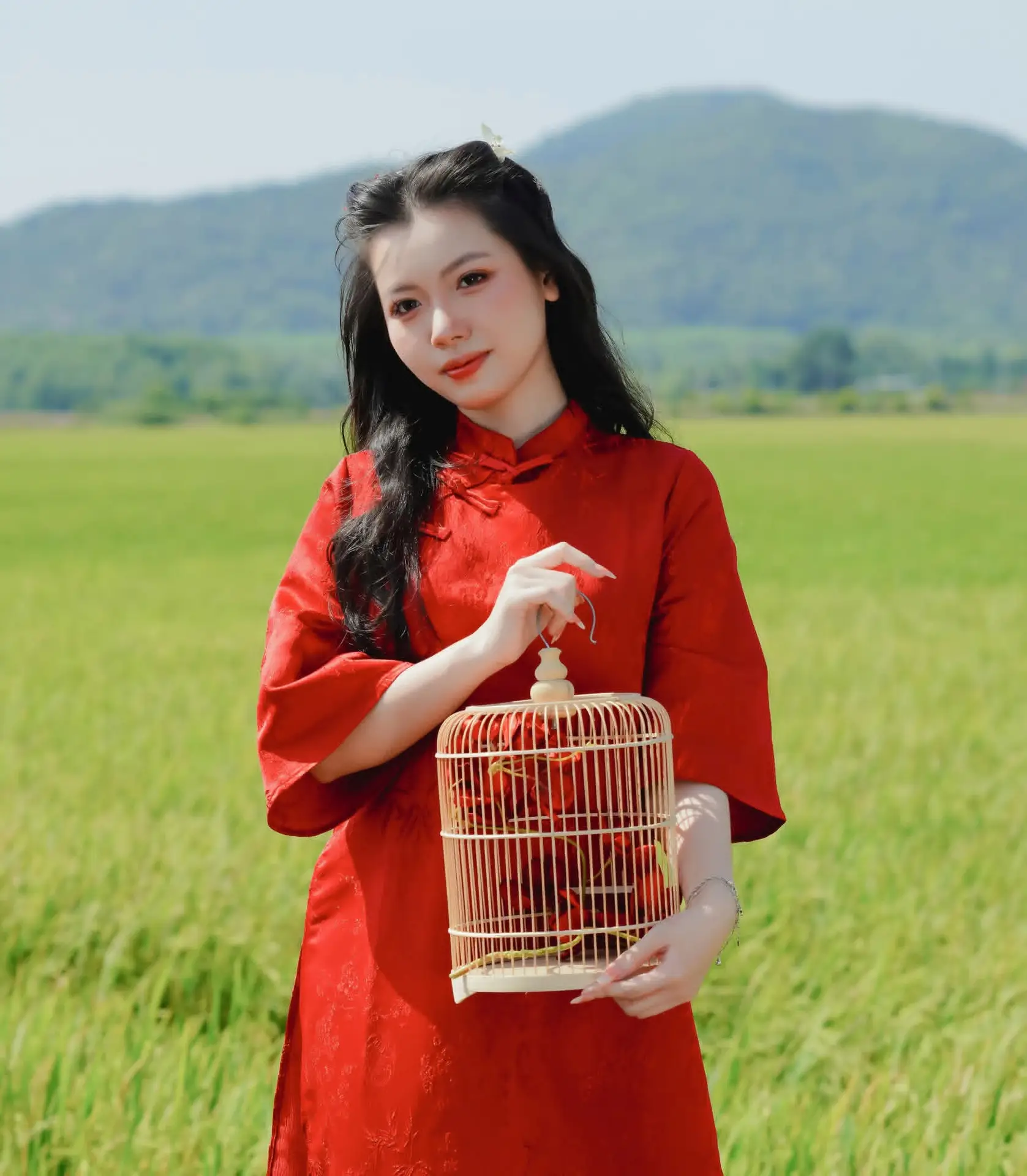 Discover the Serene Beauty: Vietnamese Girl in Red Ao Dai Amidst Green Rice Fields